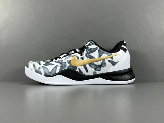 Basketball shoe with camouflage pattern and gold Nike logo on a gray background