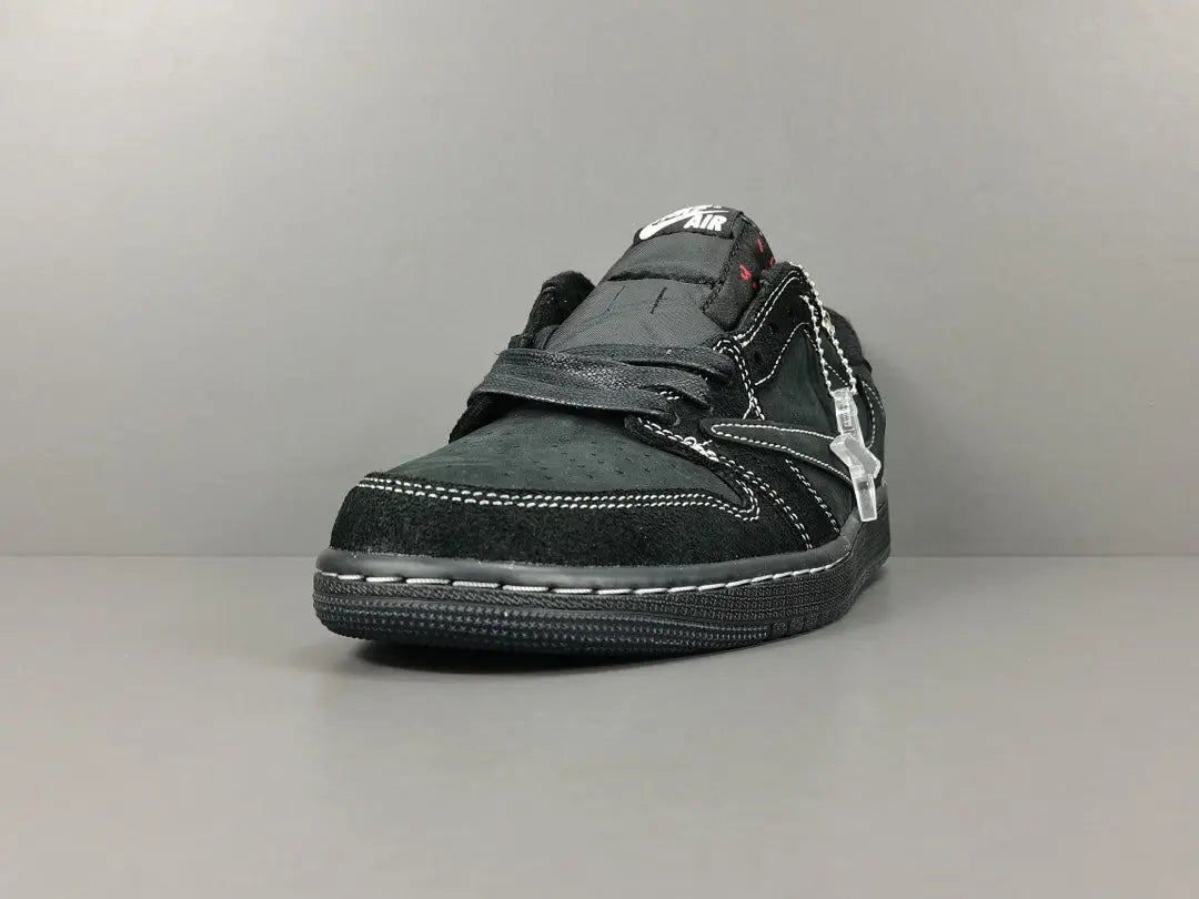 "Jordan 1 Low Travis Scott Phantom with black nubuck, white stitching, and signature reverse Swoosh."