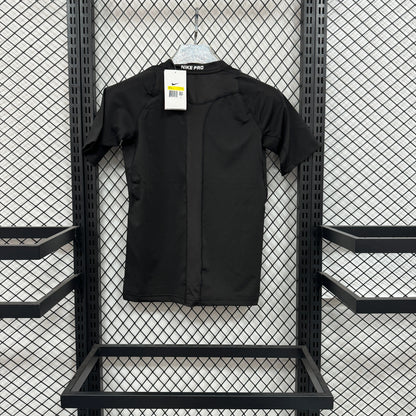 A black short-sleeve button-front overshirt or jacket from the brand NEE PJS, hanging on a white hanger against a black metal mesh display rack.
