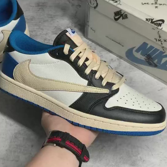 "Air Jordan 1 Low Travis Scott x Fragment – Iconic sneaker featuring a mix of white, blue, and black leather with Travis Scott’s signature reverse Swoosh and Fragment branding."